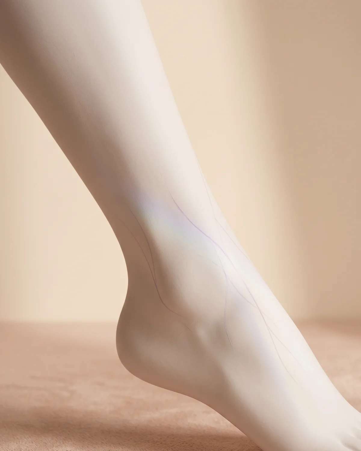 Fine lilac lines on a ceramic ankle in soft light