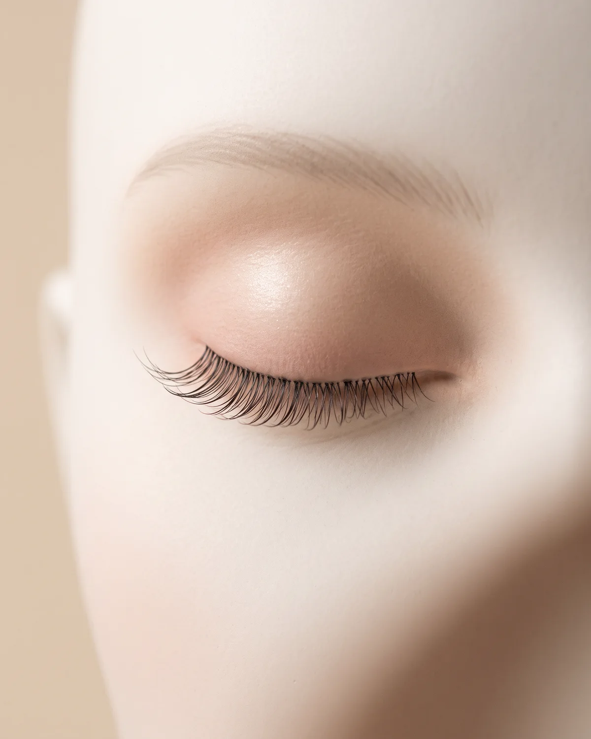 Curled lashes on a closed ceramic eye