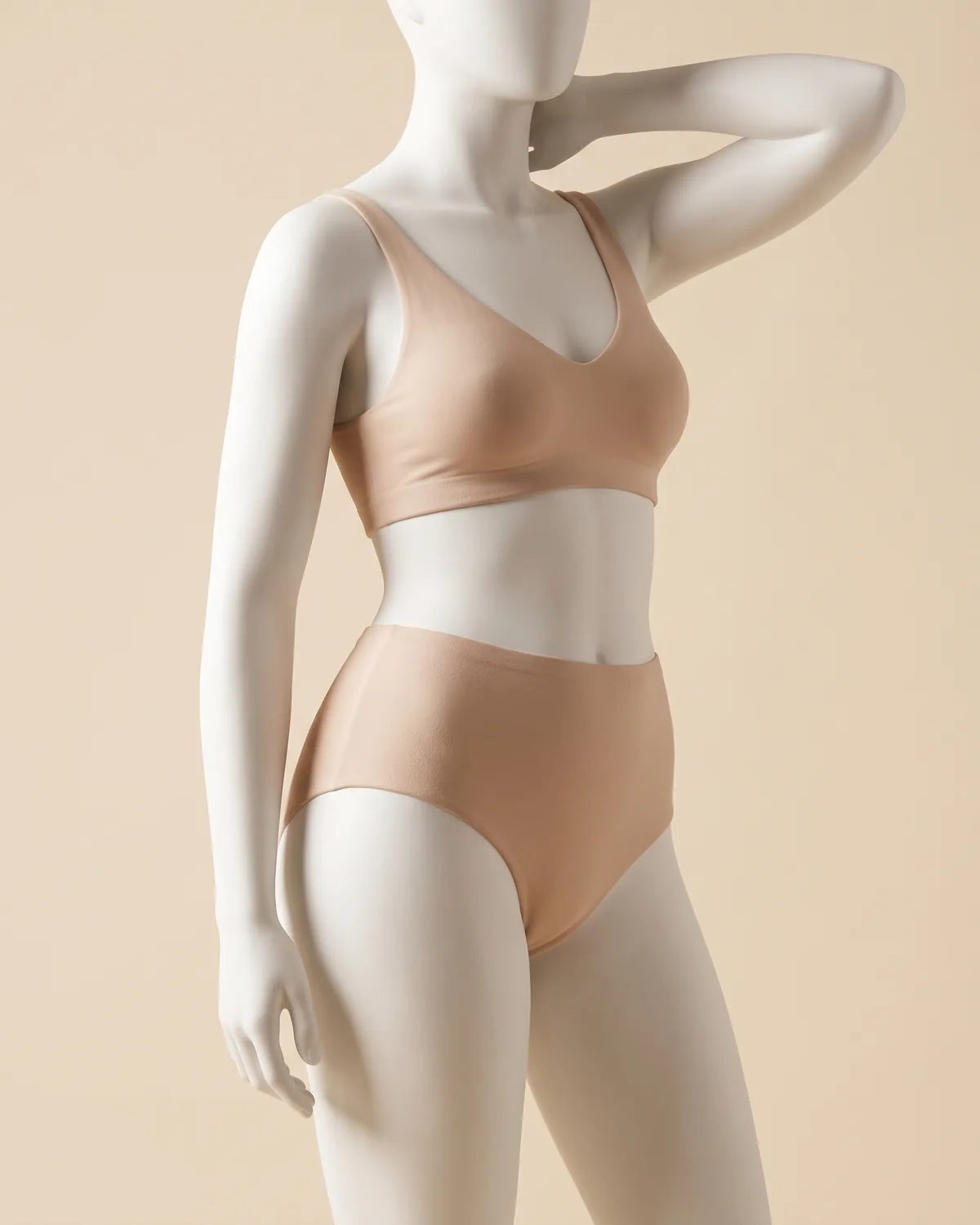 A ceramic figure from the shoulders to the knees, one arm raised